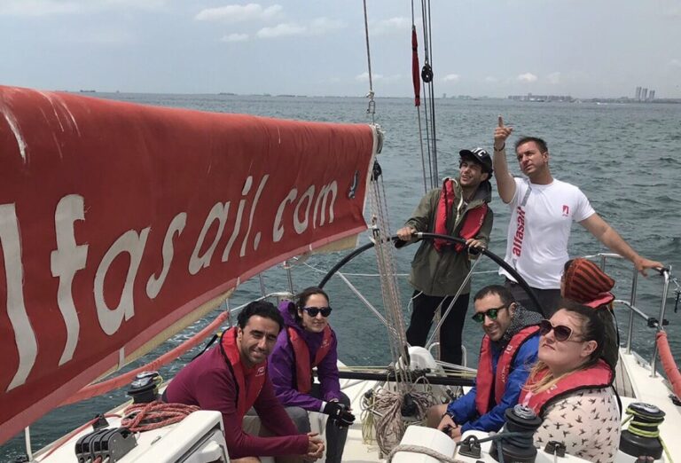 Yelken dersi alan yeni başlayan bir katılımcı dümen kullanırken
